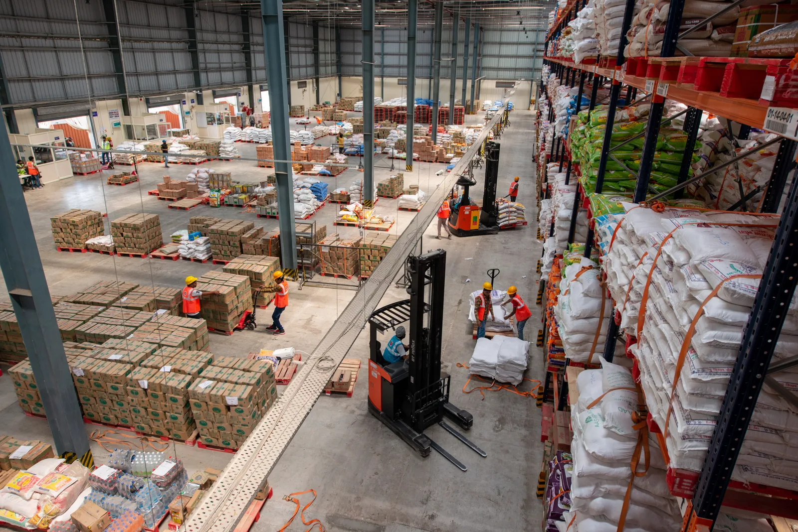 Warehouse with racked inventory and forklifts representing warehouse financing